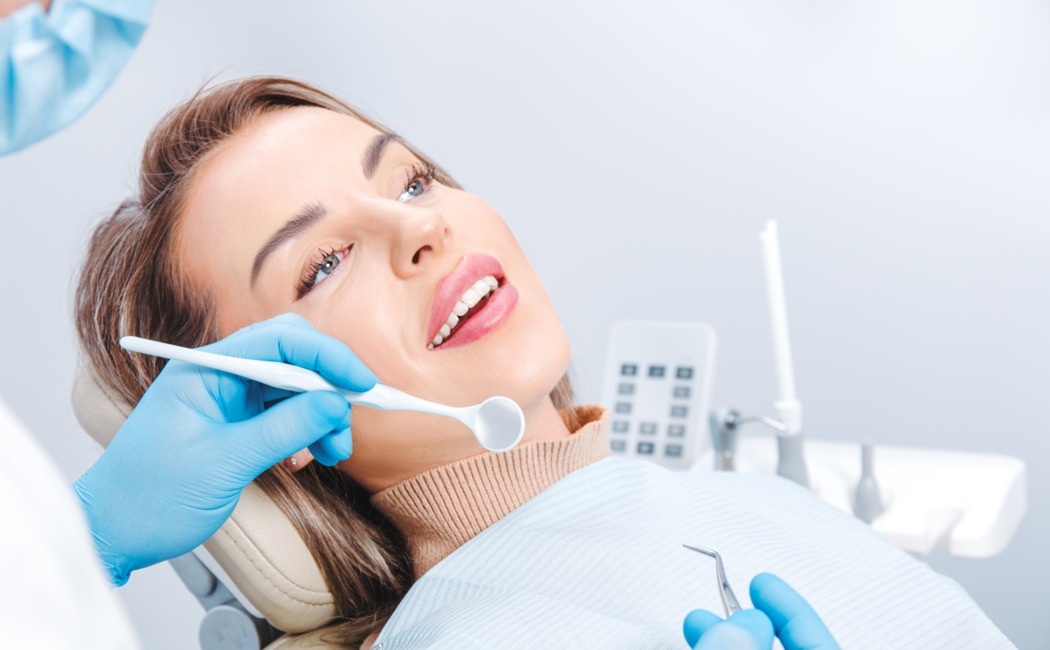 attractive-smiling-woman-at-the-dentist-appointmen-2022-11-29-20-24-13-utc